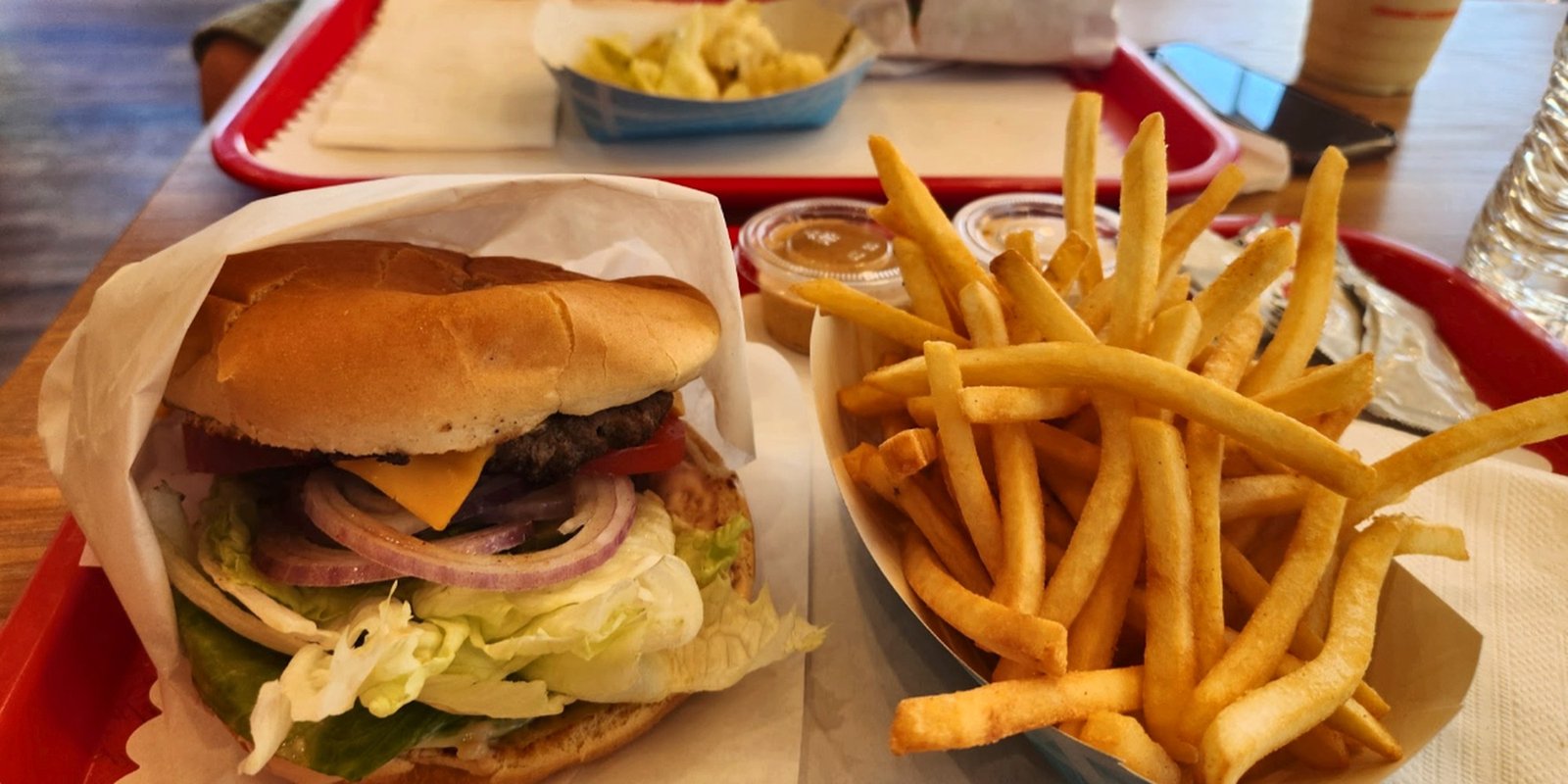 Apollo cheeseburger with fries on a red tray