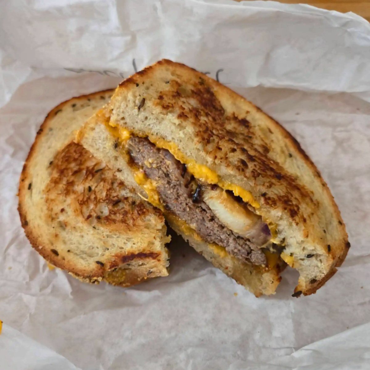 Patty melt on grilled rye with melted cheese
